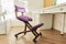 Orthopedic ergonomic kneeling chair in the interior of children`s room, home office