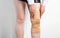 Orthopedic medical kneecap on the leg of a girl. Fixation and support of the knee joint after injury.