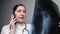 Orthopedist reports results of x-ray examination on phone