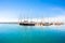 Ortigia, Syracuse, Italy / December 2018: Sailboats and yachts docked at the marina. Turquoise sea water, sunny sky, romantic