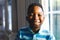 ortrait of african american boy looking at camera and smiling in living room