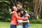 ortrait of happy asian parents, son and daughter smiling outdoors in garden