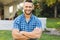 ortrait of smiling caucasian man outside house looking at camera in garden