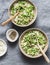 Orzo, green peas, spring herbs risotto on a gray background, top view. Vegetarian food