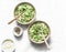 Orzo, green peas, spring herbs risotto on a light background, top view. Vegetarian food