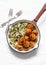 Orzo mushrooms pasta with teriyaki sauce chicken roasted meatballs in a pan on a light background, top view