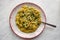 Orzo pasta vith green vegetables. Vegetarian creamy orzo cooked rissoto style