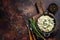 Orzo primavera with green veggies spinach. Dark wooden background. Top view. Copy space