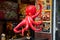 Osaka, Japan - November 2 2018: A red octopus statue hanging in front of a takoyaki restaurant in Dotonbori district, Osaka, Japan