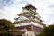 OSAKA, JAPAN - SEPTEMBER 28; 2019: The multi-storey Osaka Castle tower stands proud overlooking the city and gardens