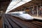 OSAKA, JAPAN - SEPTEMBER 29, 2019: The N700 G40 Shinkansen bullet train leaves Shin Osaka railway station platform on an overcast