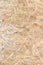 OSB panel texture. Oriented Strand Board. Chipboard building material. OSB wooden panel made of pressed sandy brown wood shavings
