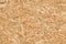 OSB Wooden panel texture. Pressed yellow orange brown wood shavings background