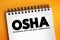 OSHA - Occupational Safety and Health Administration acronym, text concept on notepad