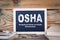 Osha, Occupational Safety and Health Administration. Chalkboard on a wooden background