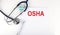 OSHA text written on the paper with a stethoscope. Medical concept