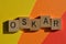 Oskar, business acronym in 3D wooden alphabet letters isolated on colourful background