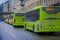 OSLO, NORWAY - MARCH, 26, 2018: Outdoor view of bright green buses waiting at a bus stop in Oslo downtown