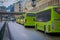 OSLO, NORWAY - MARCH, 26, 2018: Outdoor view of bright green buses waiting at a bus stop in Oslo downtown