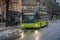 OSLO, NORWAY - MARCH, 26, 2018: Outdoor view of bright green buses waiting at a bus stop in Oslo downtown