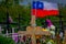 OSORNO, CHILE, SEPTEMBER, 23, 2018: Close up of selective focus of wooden cross with a small Chilean glag waving