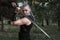 Ñosplay, dressed like a hero Geralt of Rivia from the game the Witcher, a fantastic warrior with a sword in his hands.