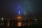 Ostankino TV tower with illumination by emblem of Moscow in fog, Russia