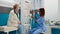 Osteopath nurse examining human skeleton bones with patient