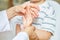 Osteopath treats child`s hand with sprain