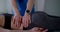 Osteopathic physician is curing spine of young woman, massaging her back