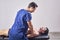 Osteopathy, sports injury rehabilitation concept. A male patient suffering from back pain and a physical therapist. Chiropractic