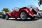 Ostrava, Czechia - 06.05.2022: High angle from behind shot of red Panther Lima MK1 convertible veteran car. People