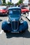 Ostrava, Czechia - 06.05.2022: High angle wide vertical frontal shot of blue Tatra 57A veteran car. People admiring