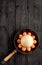 Ostrich egg, selective focuse, surrounded by chicken eggs in an old cast-iron skillet, vertical image