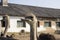 Ostrich head close up in ostrich farm. Ostriches in the paddock on the farm. Funny and strange ostrich looks into the