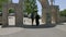 Ostrog, Montenegro - 30 June, 2017. Priest speaking with parishioner at entrance arch near Ostrog monastery. Arch