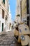 Ostuni, Italy, Apulia region, Adriatic Sea, July 9, 2019: Vespa motorcycle standing in the typical street of Ostuni