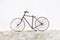 OSTUNI, ITALY - NOVEMBER 27, 2022: Old bicycle propped up against a white wall in the town of Ostuni, Italy, Europe.