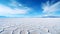 An otherworldly scene of salt flats and salt pans stretches to the horizon, reflecting the sky like a mirror