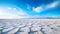 An otherworldly scene of salt flats and salt pans stretches to the horizon, reflecting the sky like a mirror