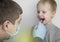 An otolaryngologist examines a child`s throat with a wooden spatula. A possible diagnosis is inflammation of the pharynx, tonsils