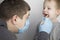 An otolaryngologist examines a child`s throat with a wooden spatula. A possible diagnosis is inflammation of the pharynx, tonsils