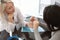 Otolaryngologist giving hearing aid to patient in hospital