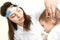 Otolaryngologist putting hearing aid in little boy\'s ear on light background