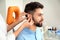 Otolaryngologist putting hearing aid in patient`s ear