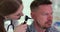 Otorhinolaryngologist examines patient ear with otoscope closeup