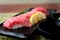 Otoro tuna sushi on black plate along with Japanese sauce and green leaf decoration, Japanese food, close up at sushi