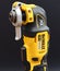 OTTERY ST MARY, DEVON - FEBRUARY 6TH 2020: Dewalt Cordless Multi Tool stands upright on its battery on a black background