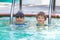 Oudoor summer activity. Concept of fun, health and vacation. Brothers boys in swim glasses sits in a pool spa in hot