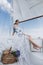 ?oung girl stands on a yacht with white sails in a flying dress